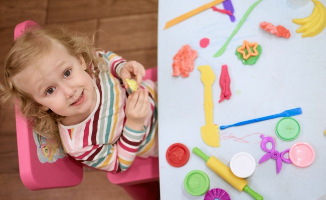 Child playing with colorful objects as a part of occupational therapy