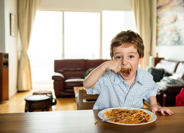 A child having good motor functions, feeding himself