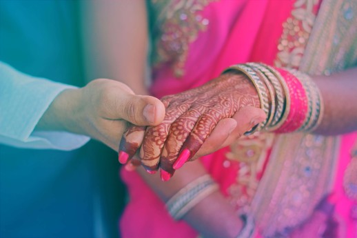 Couple holding hands indicating marriage