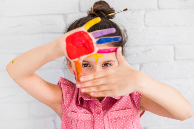 Child having colors on hand - occupational therapy