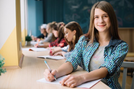 A cheerful teenager studying