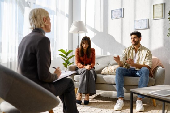 A couple discussing with marital counsellor