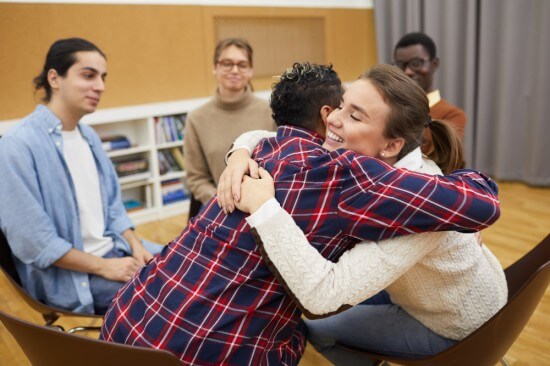 Social support - hugging a group member