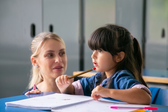 A teacher helping her student