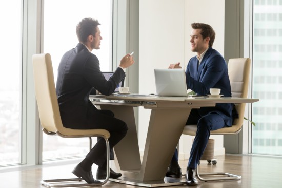 Two employees conversing with each other