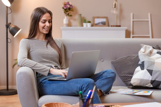 Woman working comfortably on couch