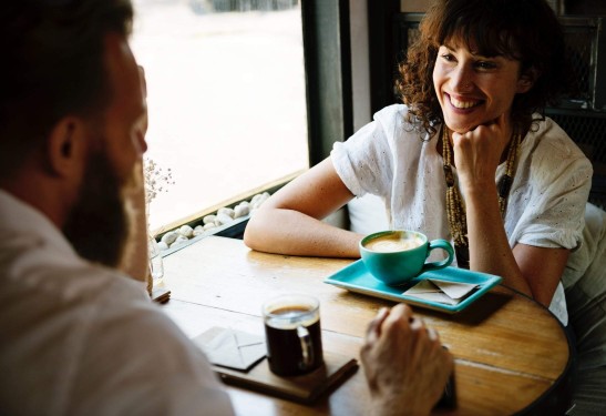 A couple having a conversation over coffee