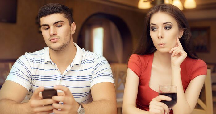 Husband engrossed in phone, wife wondering why