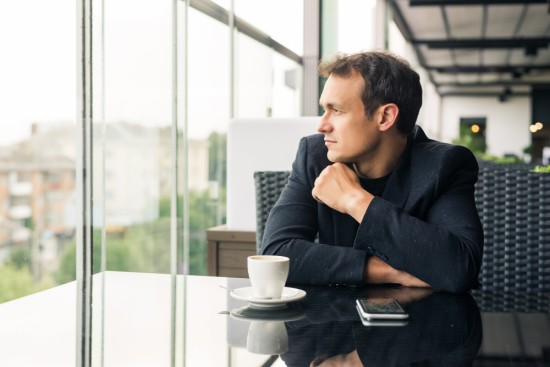 A Manager thinking near a window