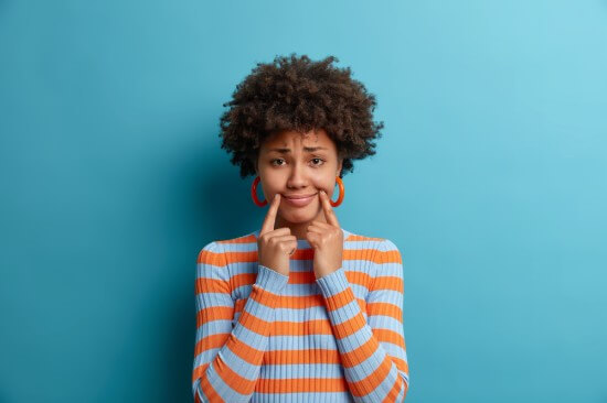 A Woman trying to look happier