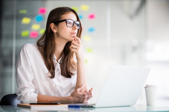 A lady employee working on Laptop