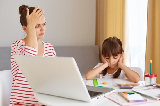 A mother working from home, tackling her kid's homework