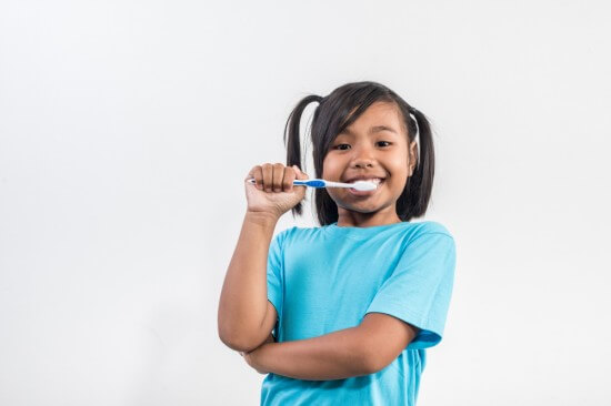 Child brushing her teeth