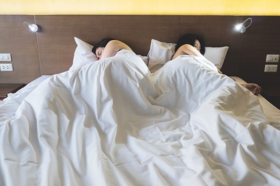 Couple bored with each other at bed