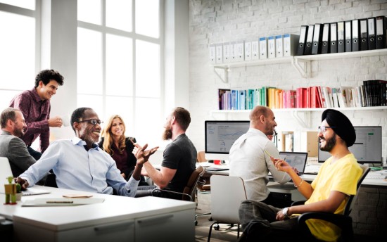 Diverse group of people interacting in office