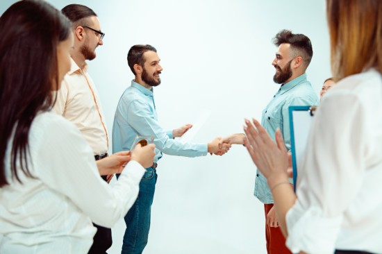 Employees congratulating a colleague