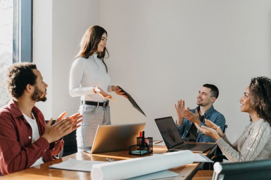 Employees congratulating a colleague