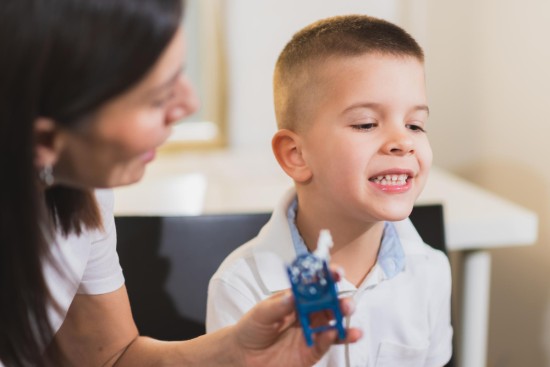 Speech therapist helping the child in Communication
