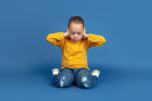 Autistic child sitting in w position