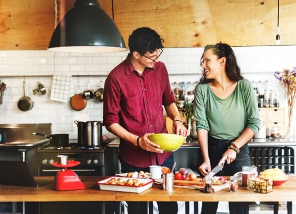 A couple Cooking together in Kitchen